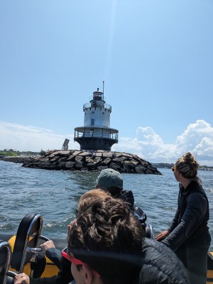 a group of people standing next to a body of water